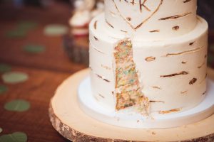 A detailed wedding cake with a hole in the middle.