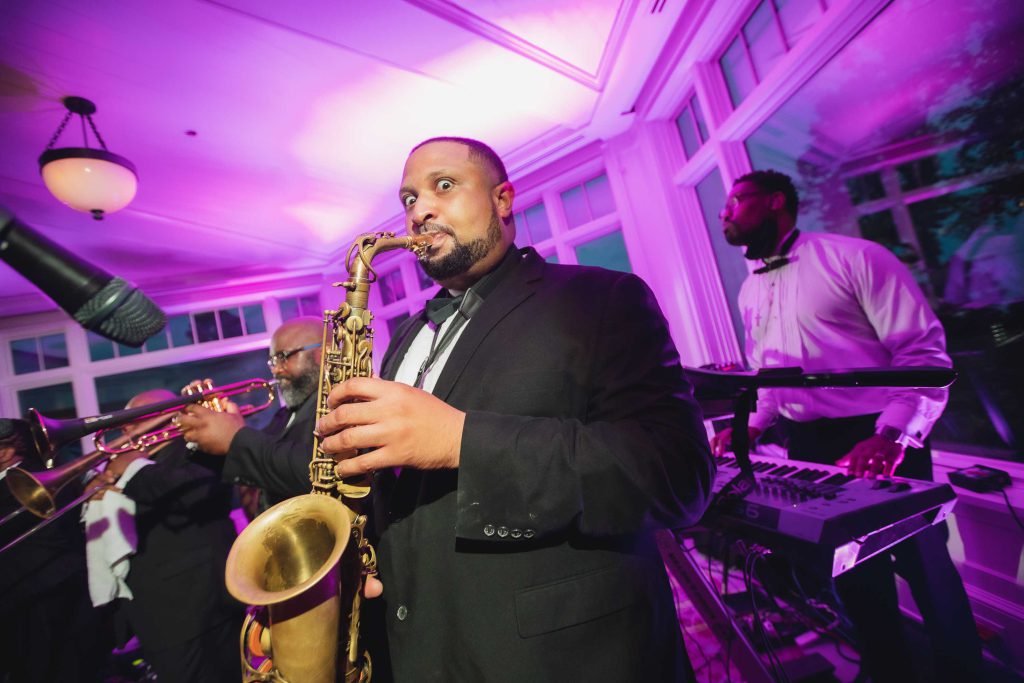 A man playing a saxophone at a wedding reception.