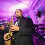 A man playing a saxophone at a wedding reception.