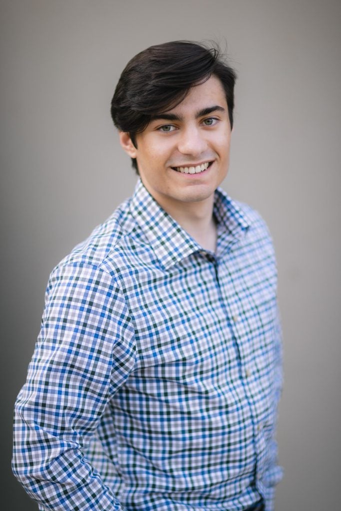A high school senior wearing a blue and white checkered shirt.