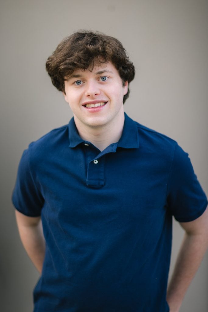 A high school senior wearing a blue polo shirt.