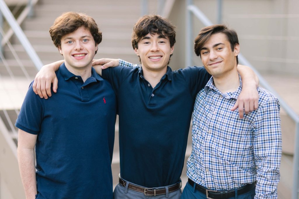 Three high school seniors posing for a portrait photo.