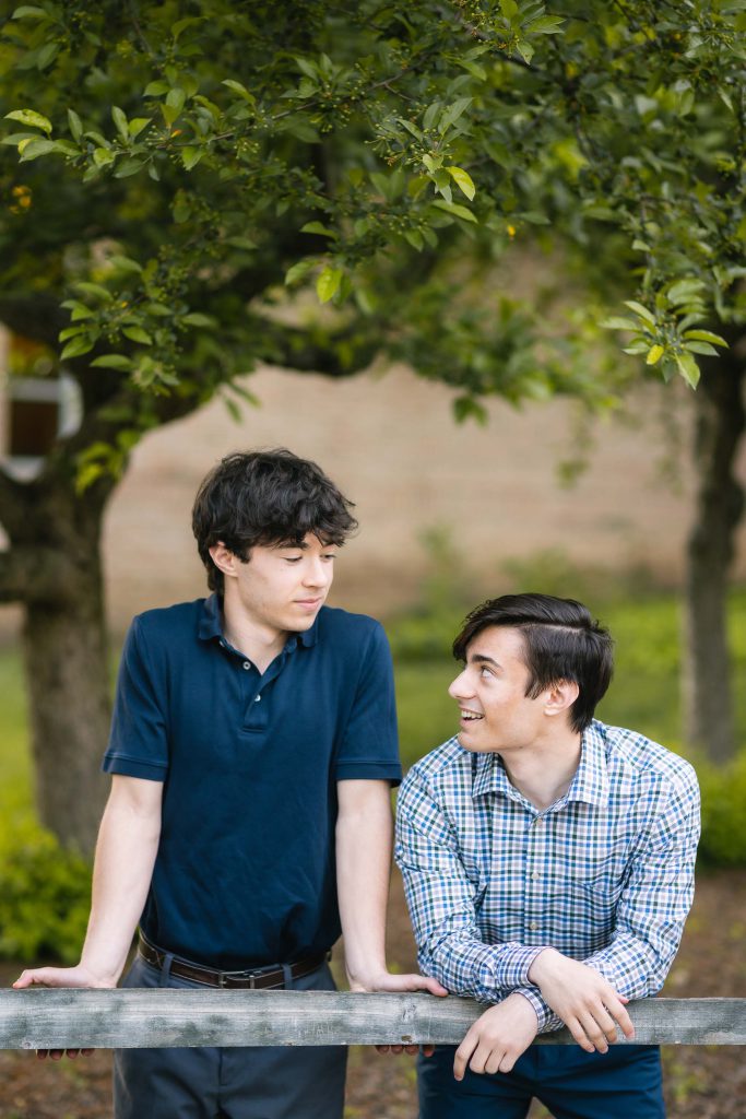 Two young men posing for a graduation portrait.