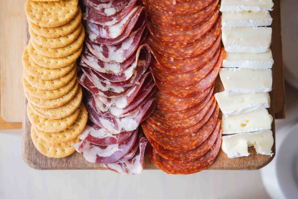 A platter of meat, cheese, crackers and crackers for a Birthday Party.