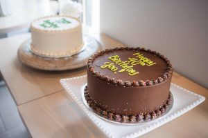 Two chocolate birthday cakes on a table at a birthday party.