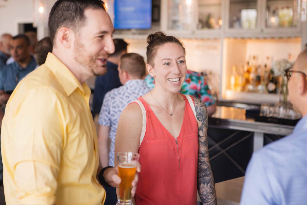 A group of people at a birthday party talking to each other.