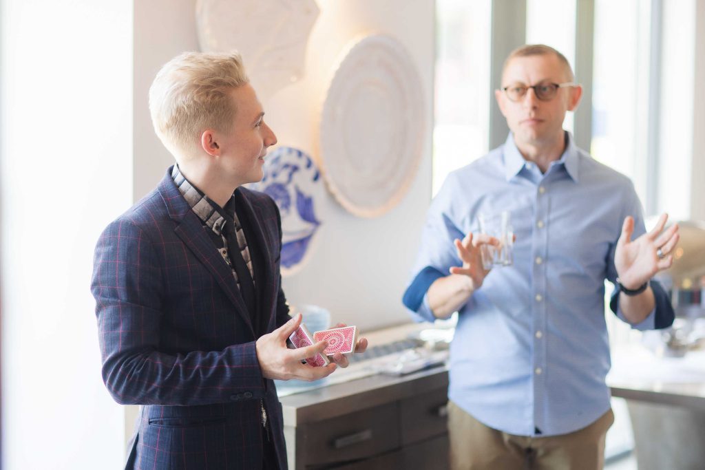 Two men celebrating a birthday together in a room.