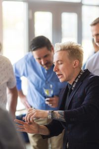 A man wearing a jacket at a birthday party.