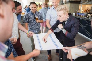 People standing around a table at a birthday party.