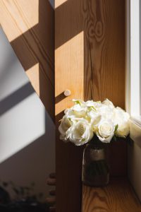 White roses on a window sill.