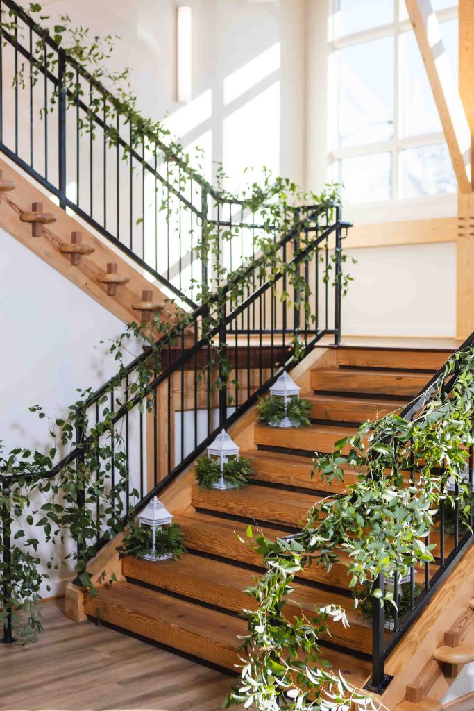 A wedding staircase adorned with plants and intricate details.