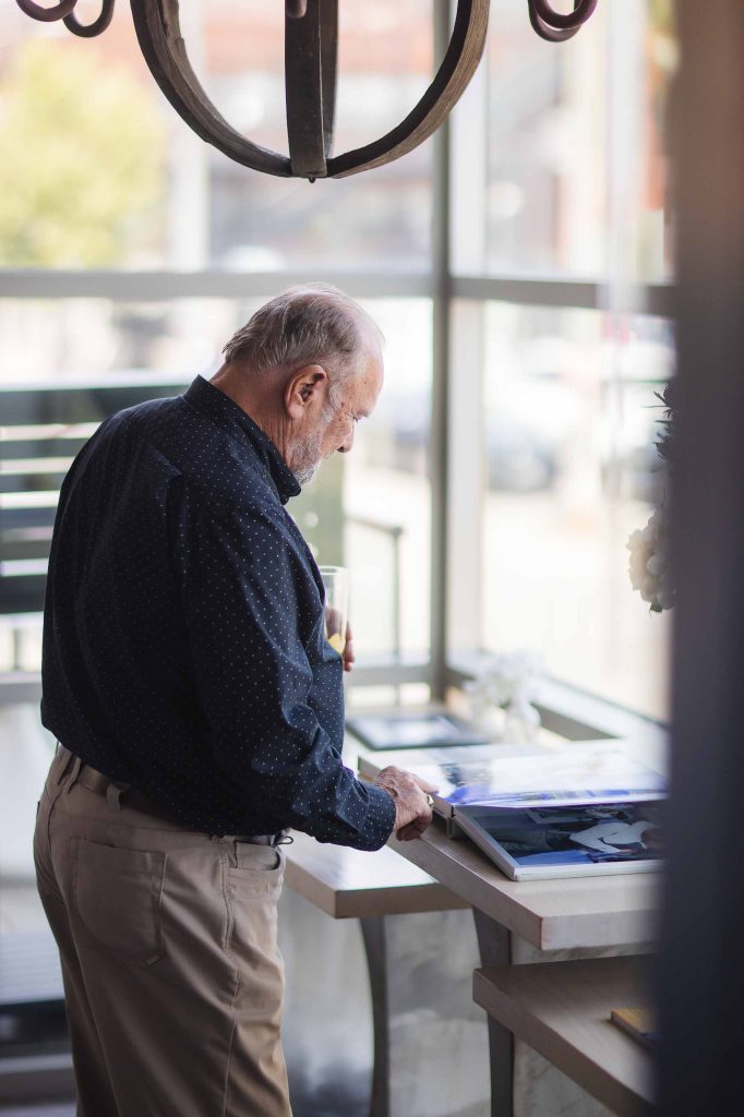 A man using a tablet computer at a birthday party in a restaurant.