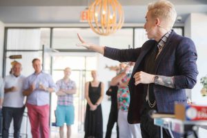 A man is giving a presentation at a birthday party.