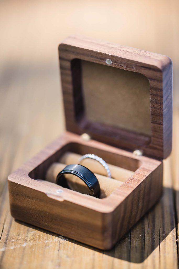 Wedding rings with exquisite details beautifully presented in a wooden box.