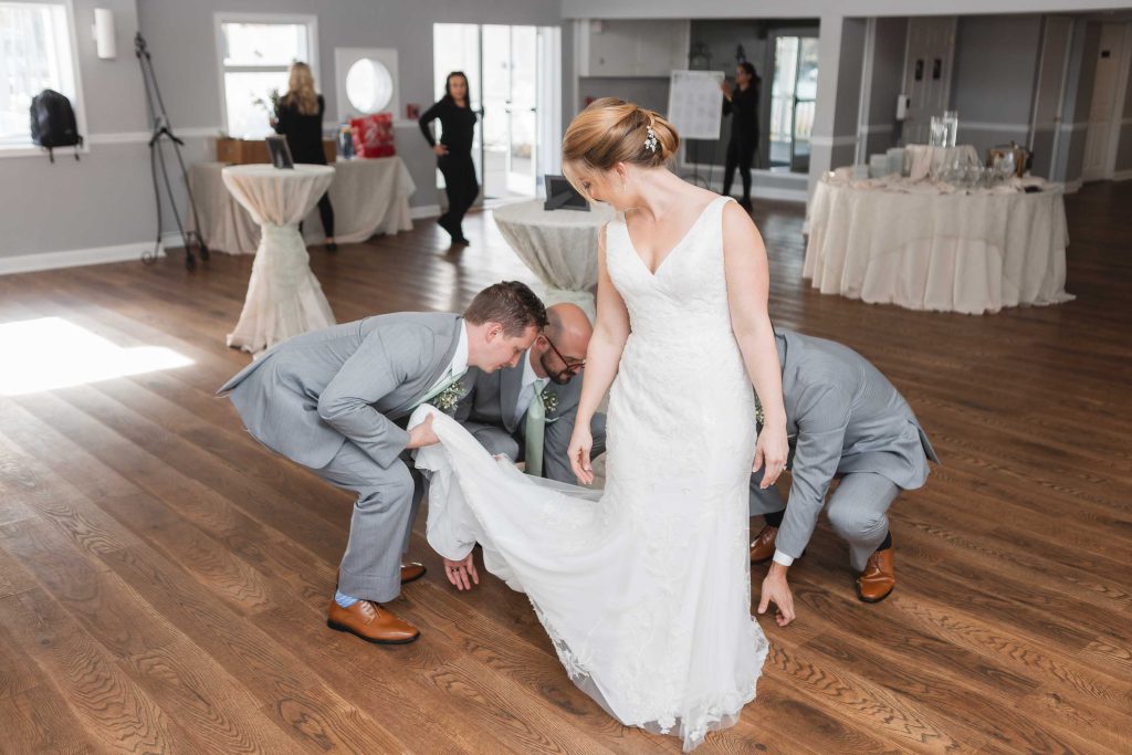 A candid bride preparing at her wedding reception.