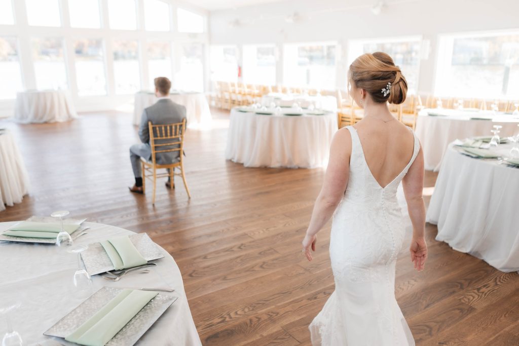 A bride walks down the aisle at a wedding reception.