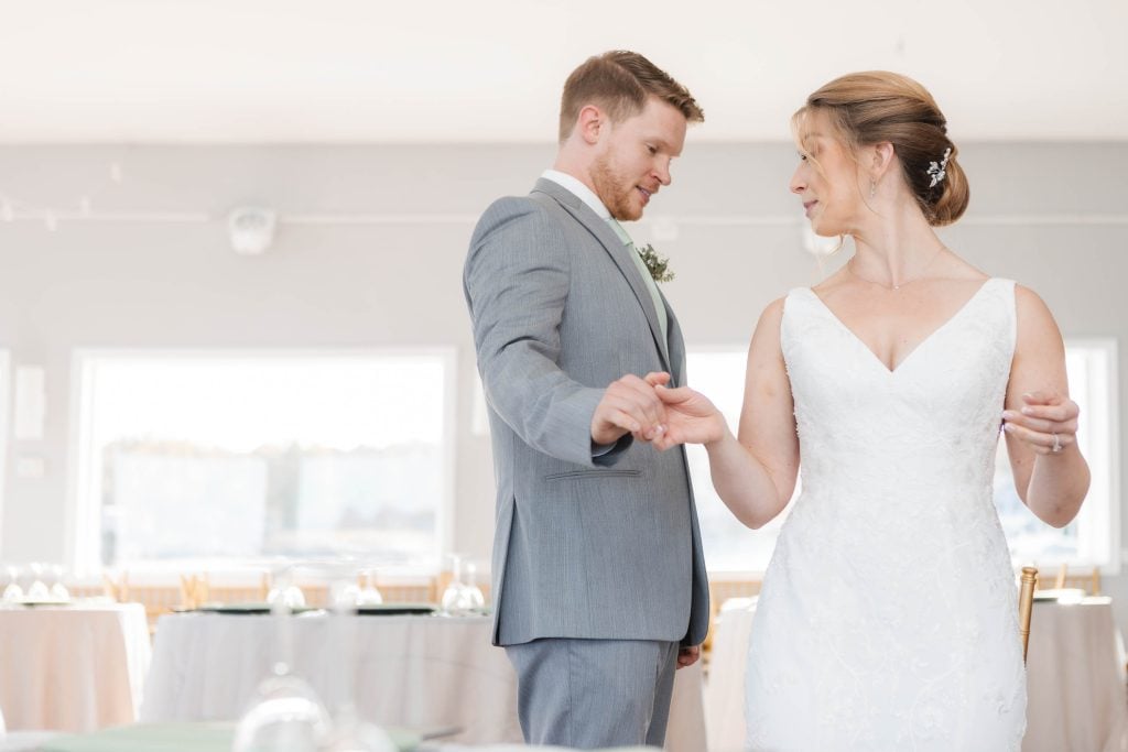 A candid bride and groom dancing at their wedding reception.