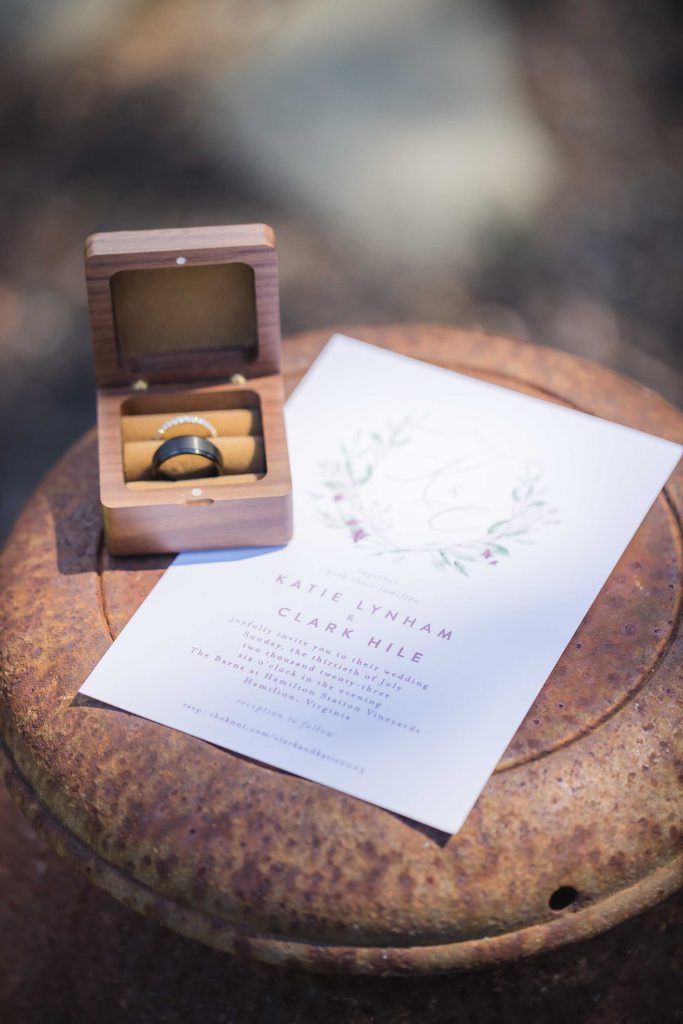 A detailed wedding ring displayed in a wooden box.