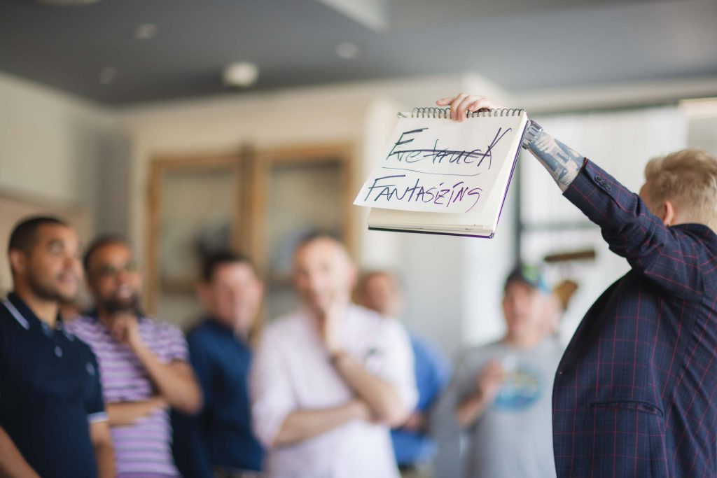 A group of people holding up a sign that reads 'employee engagement' at a celebration.