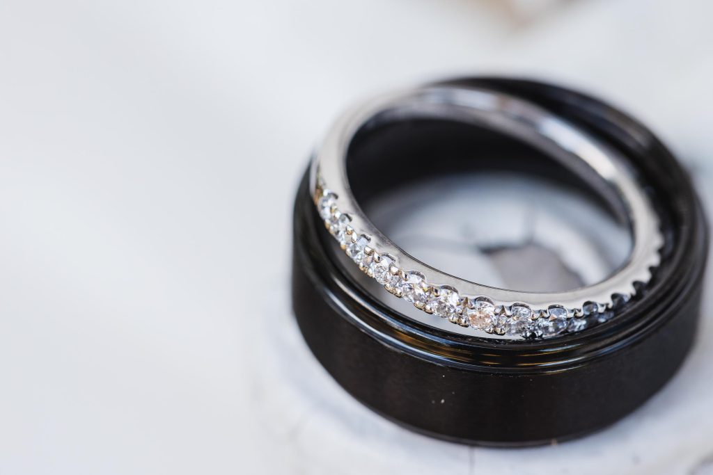 A wedding ring resting on a marble surface, showcasing intricate details.