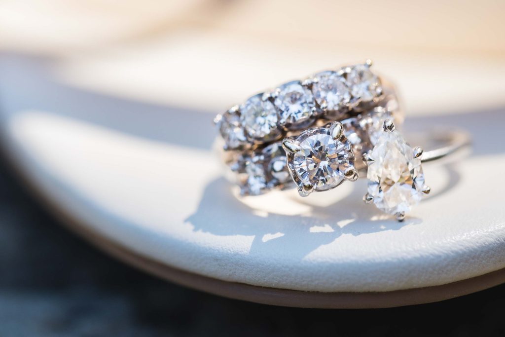 A wedding ring sits on top of a shoe, highlighting intricate details.