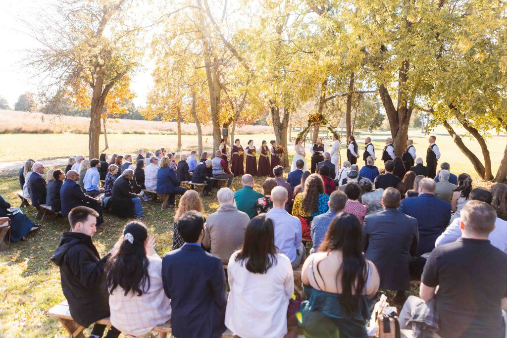 A wedding ceremony with a large group of people.