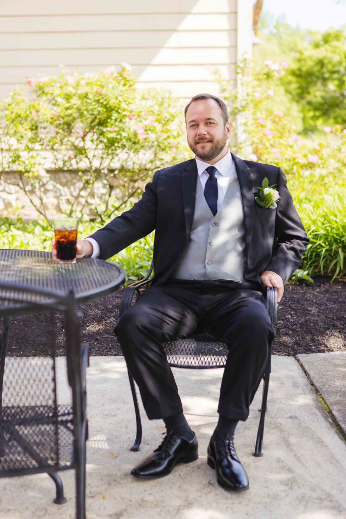 A man in a suit preparing for a wedding.