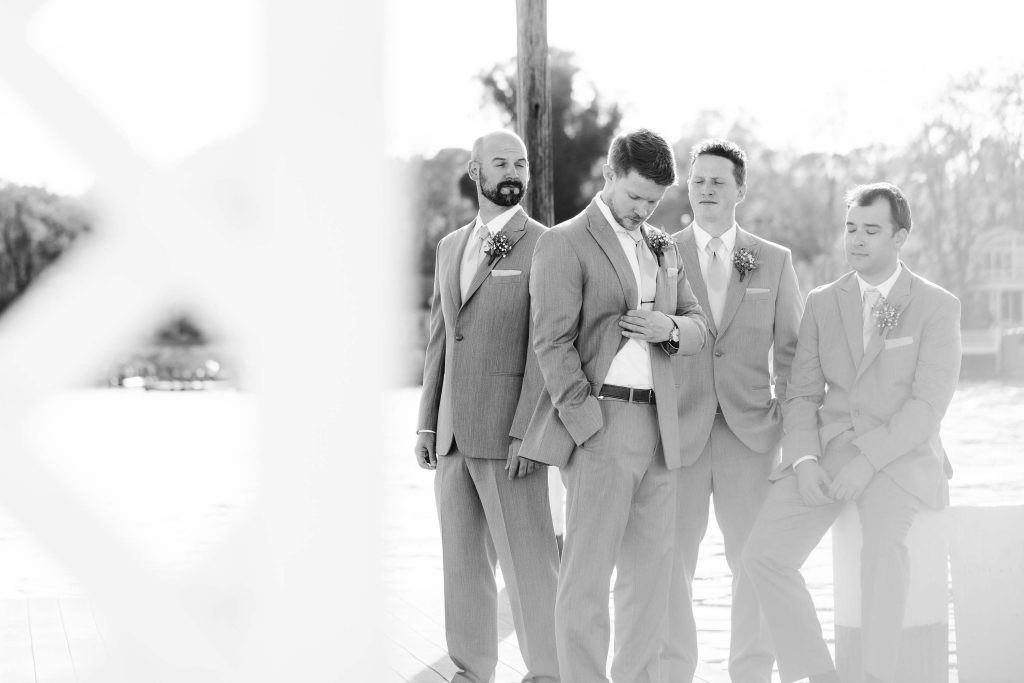 A group of groomsmen posing for a wedding portrait.