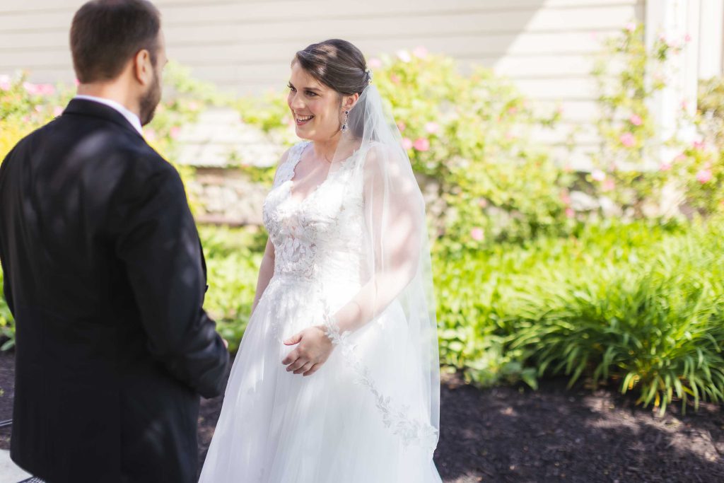A candid bride and groom look at each other during their wedding ceremony.