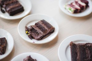 A slice of chocolate cake at a Birthday Party.