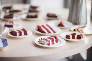 A table with a variety of cake at a birthday party.