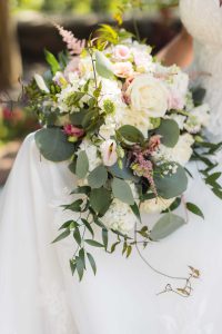 A bride holds a bouquet of flowers at her wedding.