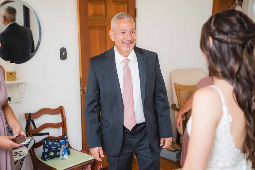 A candid groom in a suit preparing for his wedding.