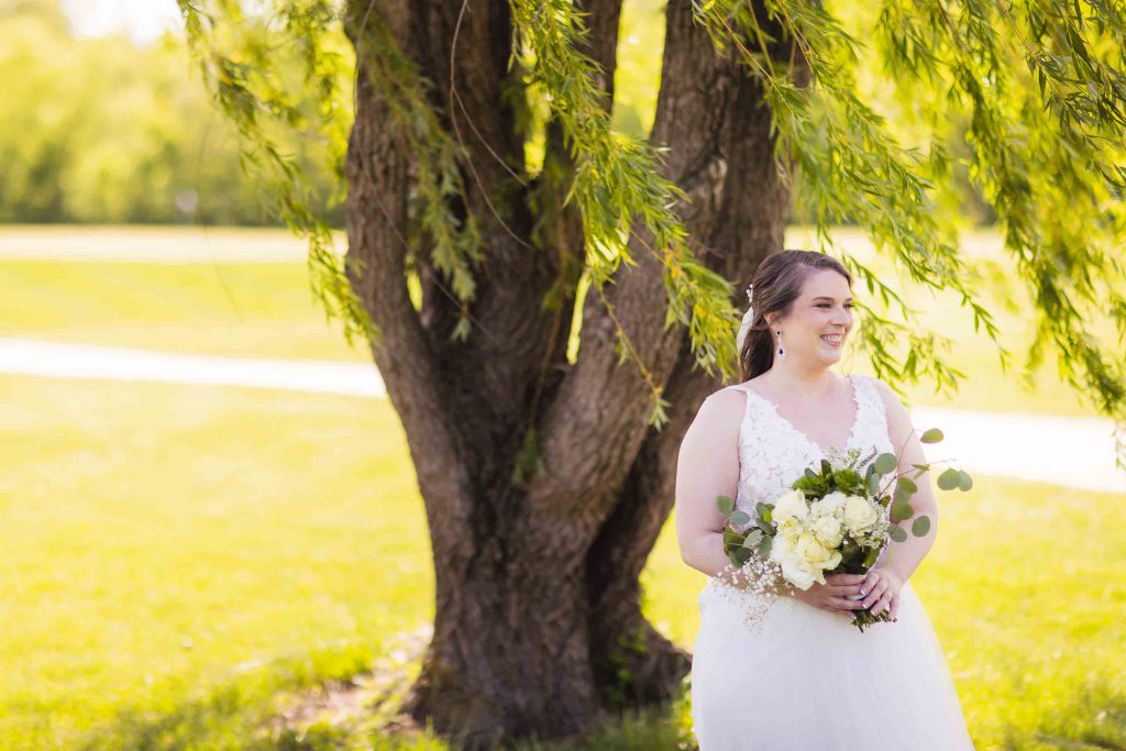A wedding portrait under a willow tree.