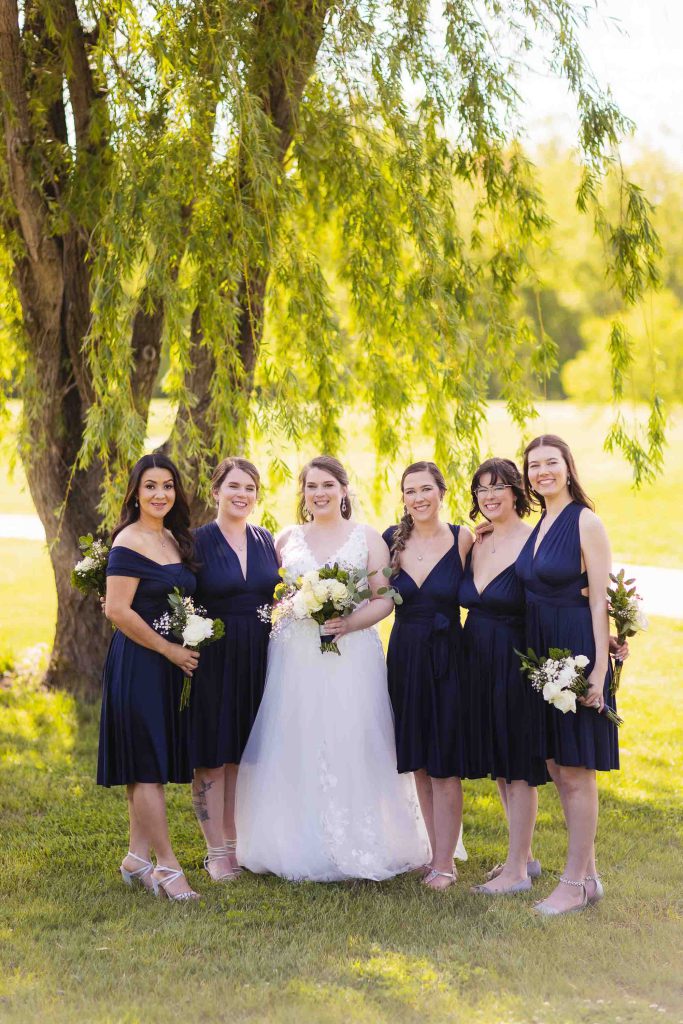 A group of bridesmaids posing for a wedding portrait.