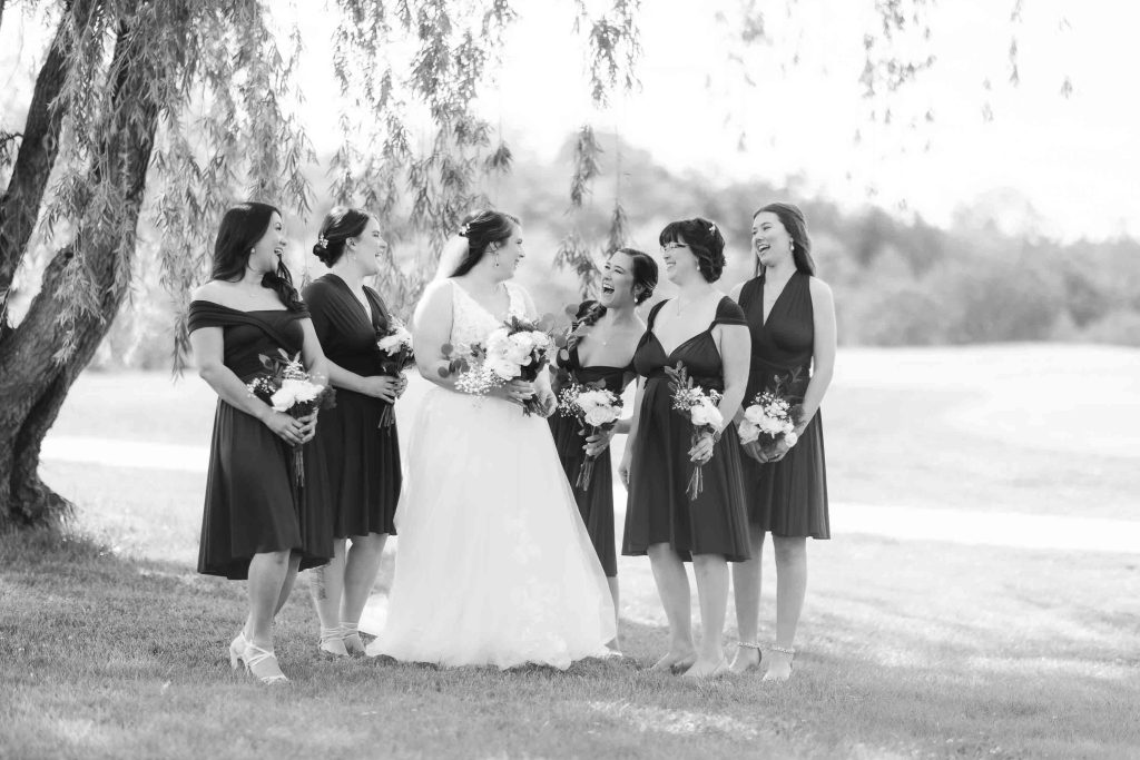 Wedding portrait of bridesmaids in front of a tree.
