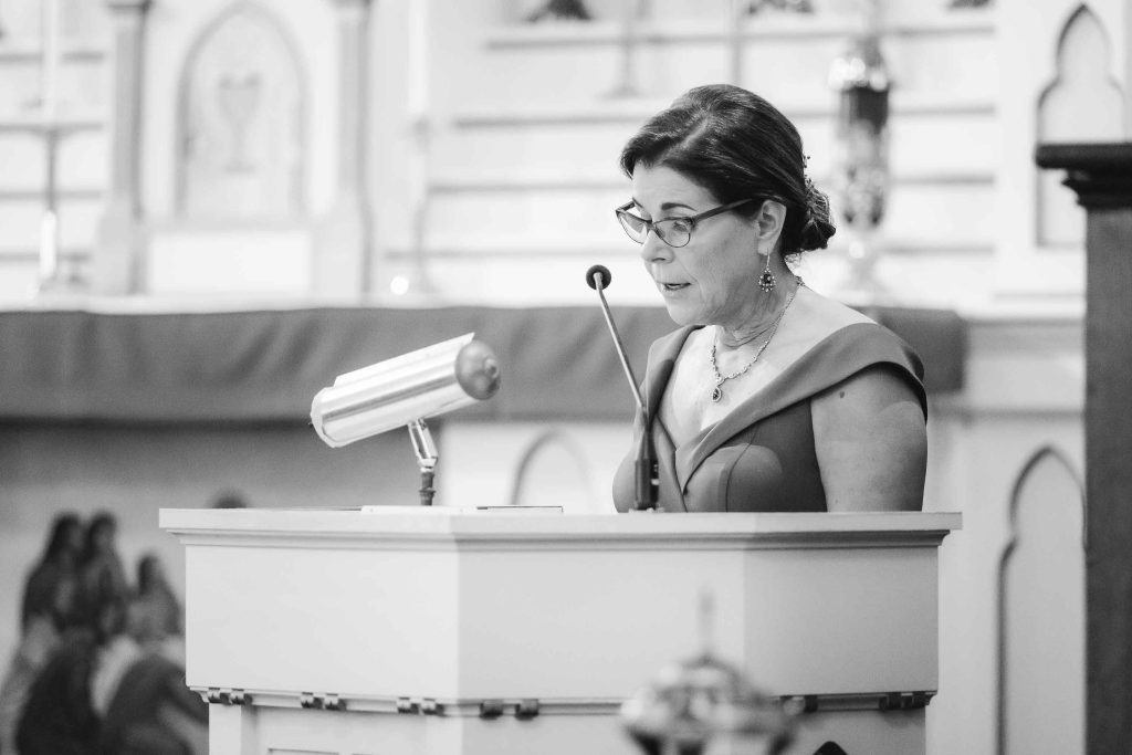 A woman giving a speech at a wedding ceremony.
