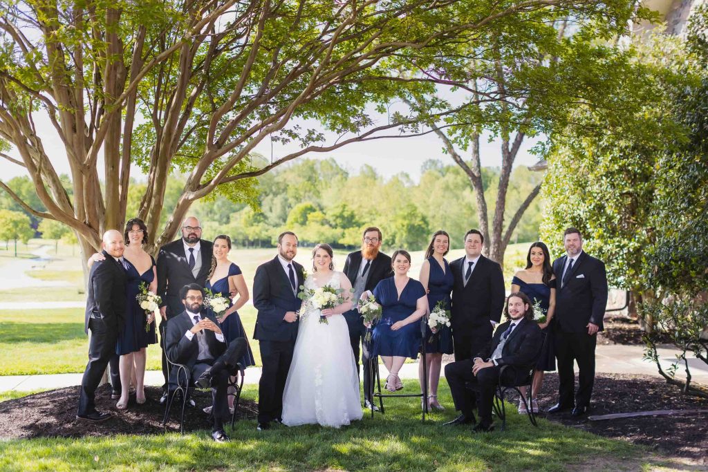 A wedding portrait in front of a tree.