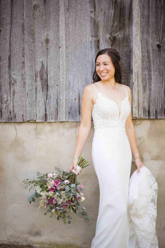 A bride in a white wedding dress posing for a portrait.