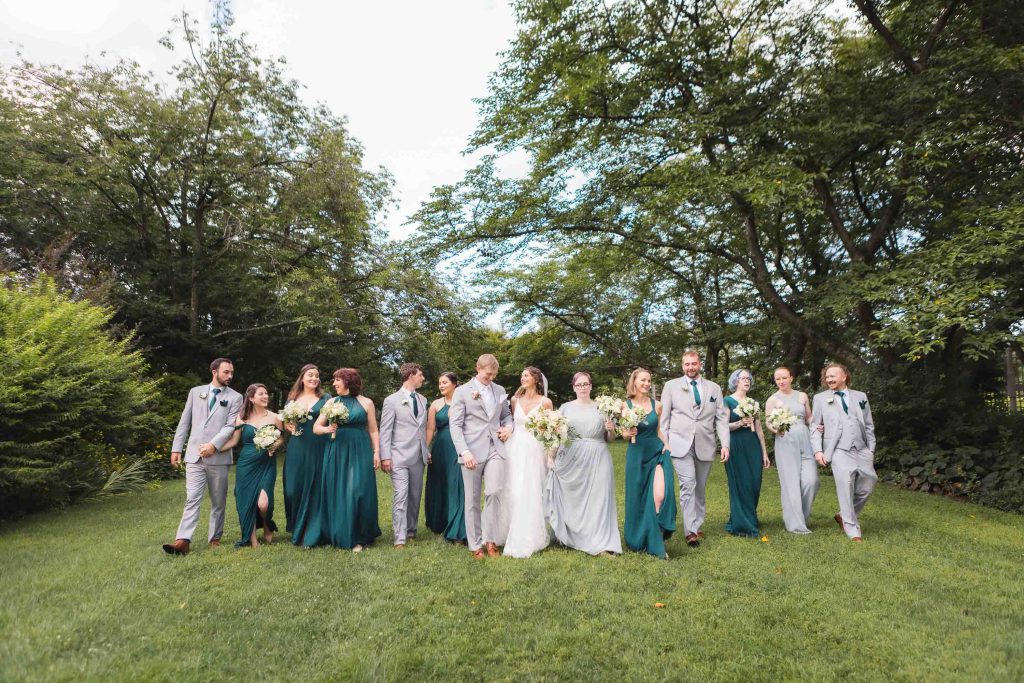 A group of bridesmaids and groomsmen posing for a wedding portrait.