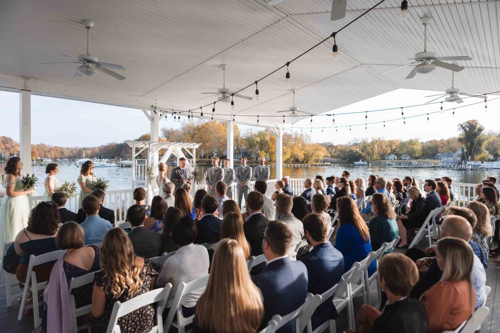 A deck wedding ceremony overlooking a lake.