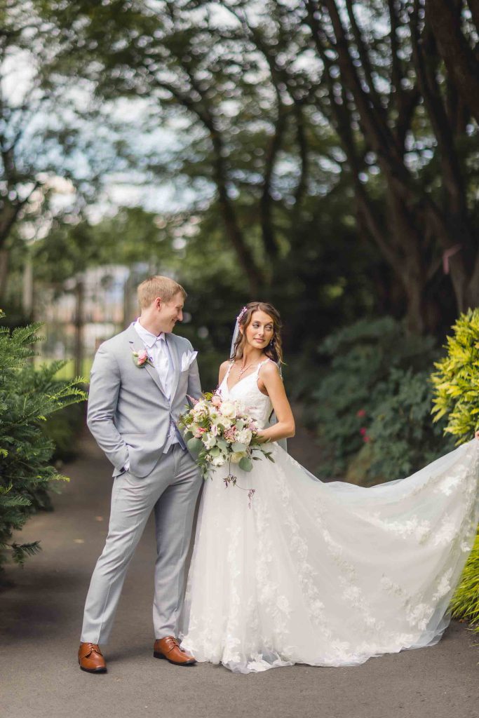 A wedding portrait captured of a bride and groom in a park.
