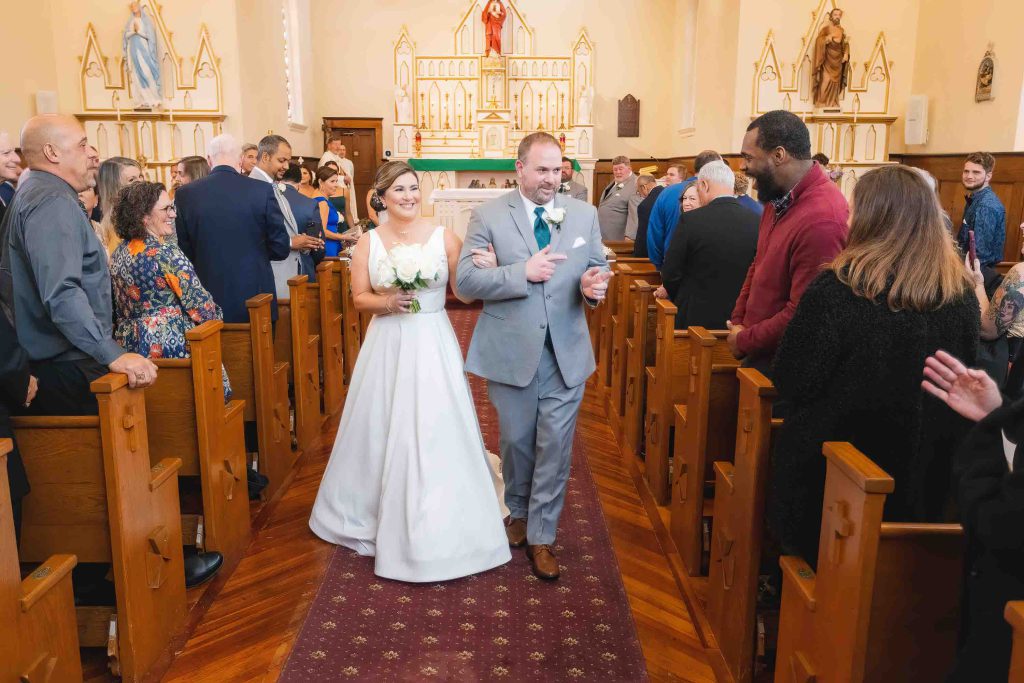 A bride and groom participating in their wedding ceremony at a church.
