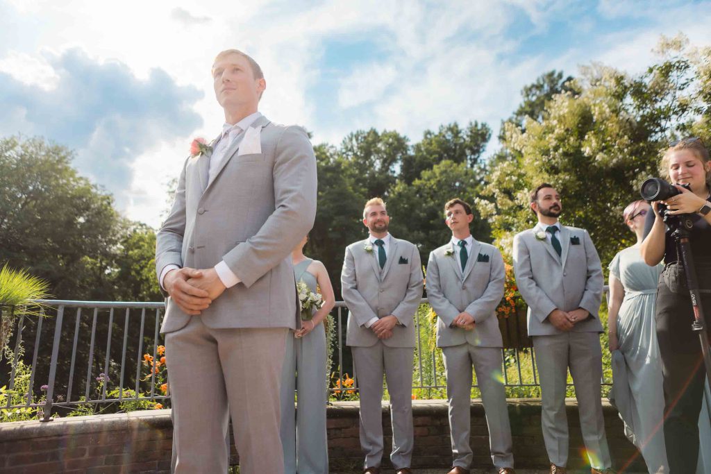 A group of groomsmen participating in a wedding ceremony.