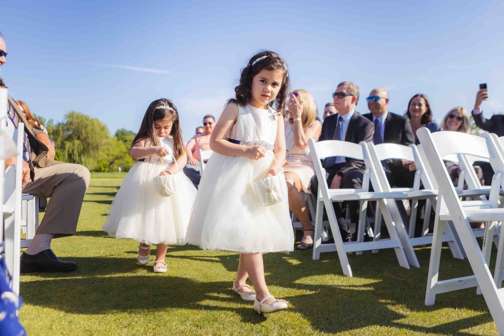 Two little girls participating in a wedding ceremony.