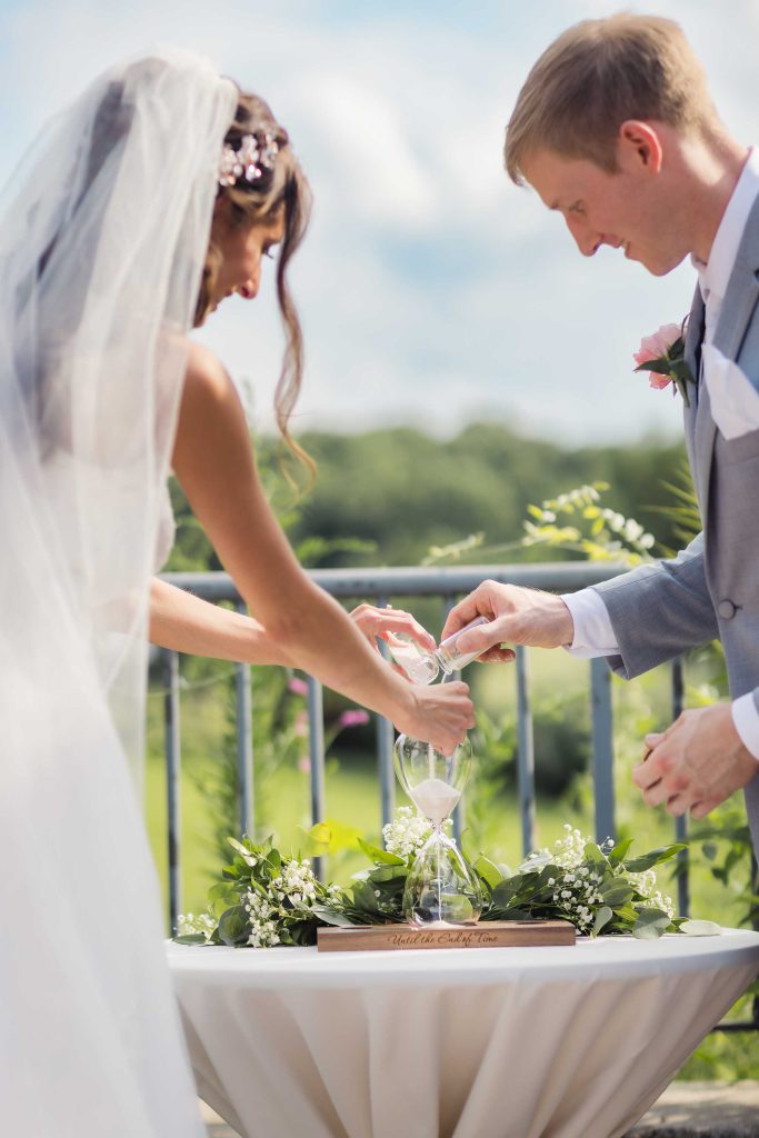 The bride is wearing a white dress at the wedding ceremony.
