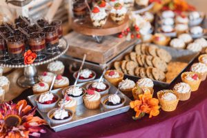 A wedding dessert table with cupcakes and other desserts.
