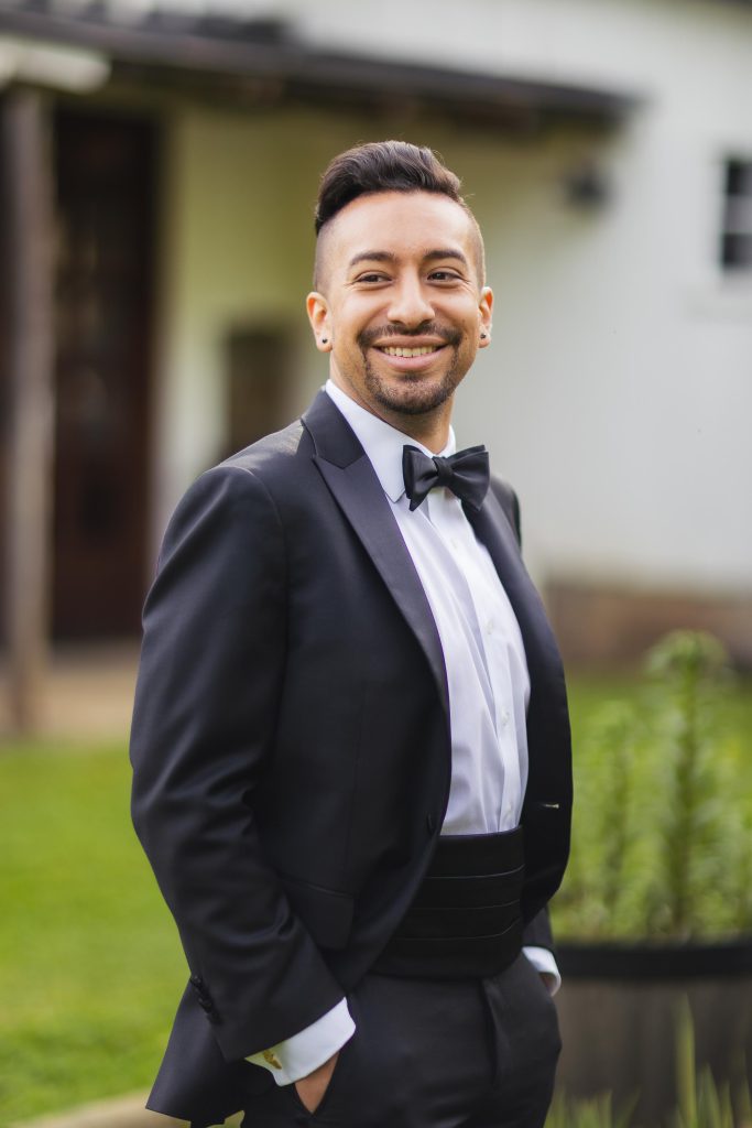 A man in a tuxedo at a wedding.