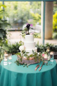 Detailed wedding cake displayed in a garden.