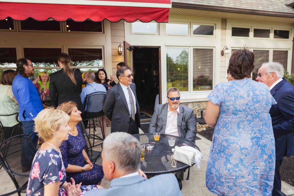 A group of people gathered around a table at a wedding reception.